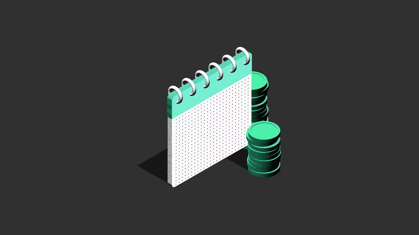 A spiral-bound calendar stands next to a stack of green coins on a dark background.