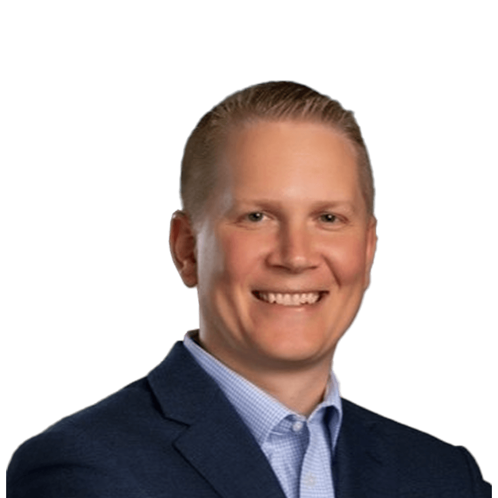 Smiling man in a blue suit and light blue shirt, with short blonde hair, against a plain white background.